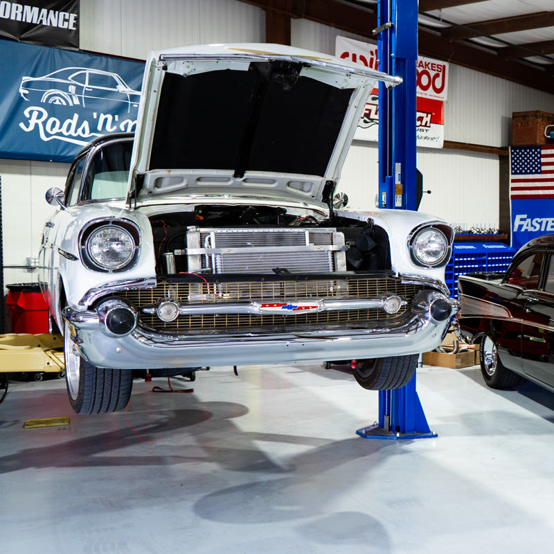 Classic car with open hood in a garage setting